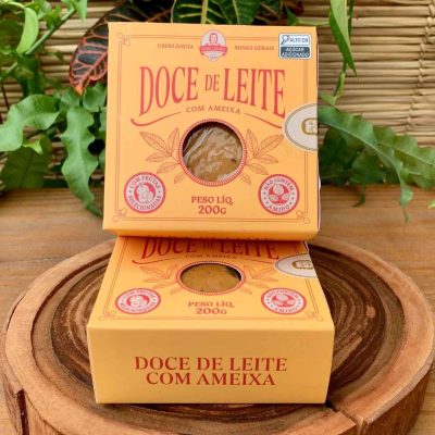 Doce de leite de corte com ameixa Dona Lázara, em embalagem especial sobre mesa de madeira.