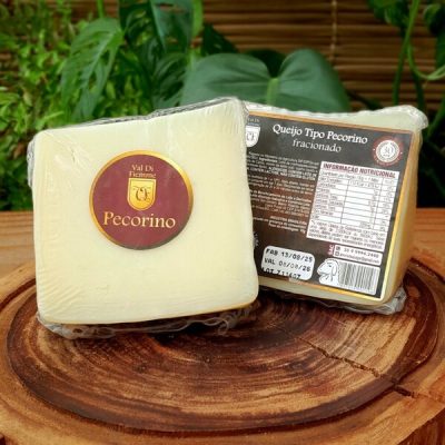 Queijo Pecorino Val di Fiemme fracionado e embalado, sobre mesa de madeira.